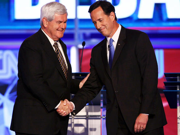 Republican presidential candidates Newt Gingrich, left, and Rick Santorum shake hands before the start of a presidential debate sponsored by CNN and The Tea Party Express at the Florida state fairgrounds Sept. 12, 2011, in Tampa, Fla. 