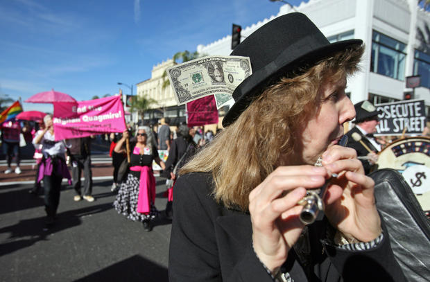 Occupy protesters march along Colorado Boulevard during the 123rd Tournament of   Roses Parade in Pasadena, Calif., Monday, Jan. 2, 2012. Several hundred Occupy   protesters marched at the end of the Rose Parade in a prearranged   demonstration. 