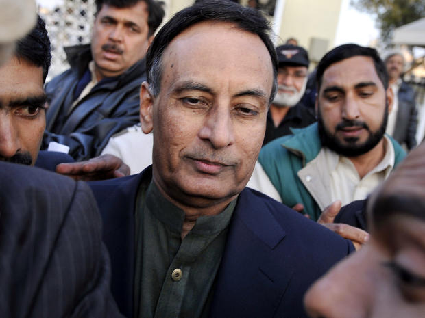 Pakistan's former ambassador to the United States, Husain Haqqani, center, exits the Supreme Court after meeting his lawyer in the secret memo scandal case in Islamabad Dec. 22, 2011. 
