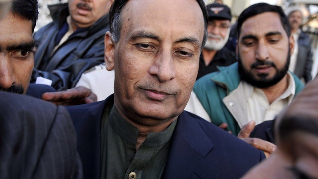 Pakistan's former ambassador to the United States, Husain Haqqani, center, exits the Supreme Court after meeting his lawyer in the secret memo scandal case in Islamabad Dec. 22, 2011. 