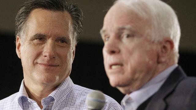 Mitt Romney listens at left, as Sen. John McCain speaks 