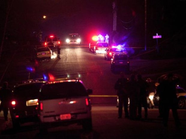 Police officers and emergency crew are seen near 3268 Jackson Street in Ogden, Utah