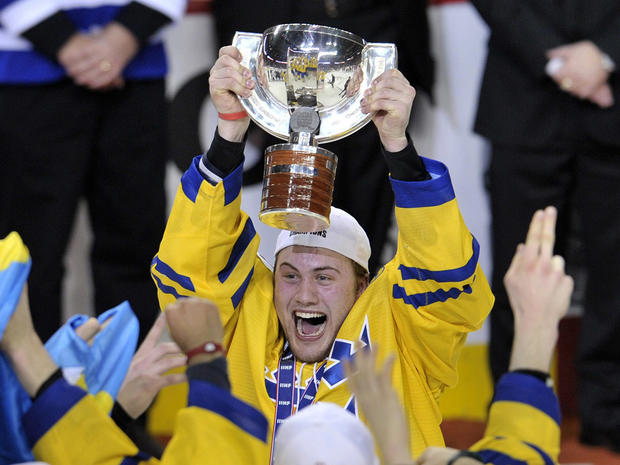 Johan Larsson holds the championship trophy 
