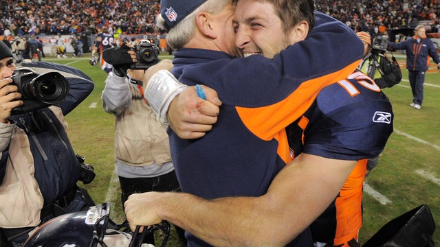 Tim Tebow hugs coach John Fox after winning 30-23  