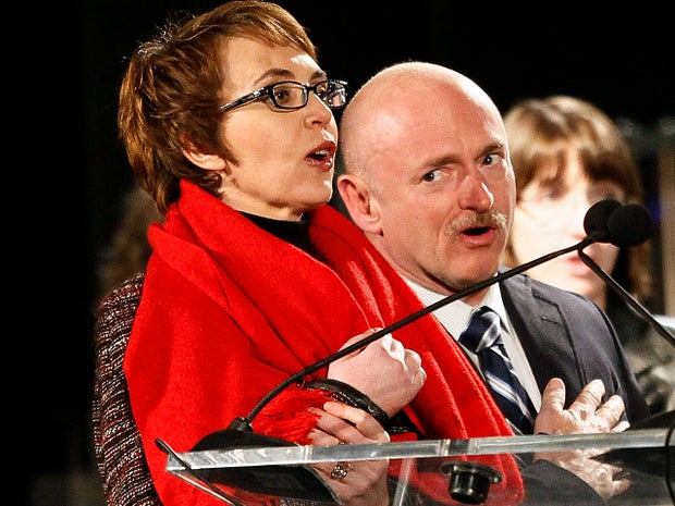 Rep. Gabrielle Giffords leads the Pledge of Allegiance accompanied by her husband, former astronaut Mark Kelly, Jan. 8, 2012, in Tucson, Ariz., at the start of a memorial vigil remembering the victims and survivors one year after the Arizona congresswoman was wounded in a shooting that killed six others. 