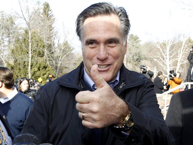 Former Massachusetts Gov. Mitt Romney gives a thumbs up as he campaigns on primary day outside a polling station at Webster School in Manchester, N.H., Jan. 10, 2012. 