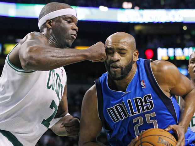 Vince Carter makes contact with the fist of Jermaine O'Neal  