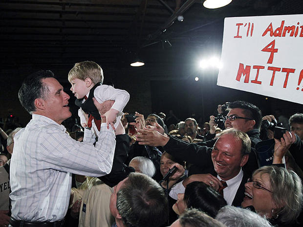 Republican presidential candidate, former Massachusetts Gov. Mitt Romney, picks up a child as he campaigns at The Hall at SenateÃƒÂ¢??s End, in Columbia, S.C., Jan. 11, 2012. 