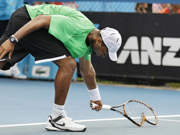 Donald Young smashes his racquet in frustration  