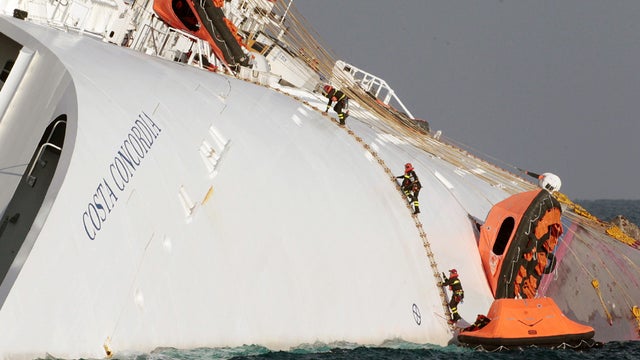 Firefighters climb onto the Costa Concordia 