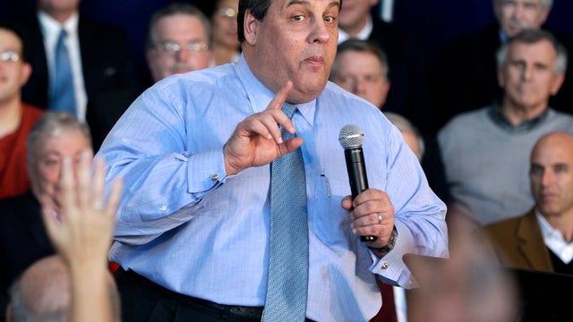 New Jersey Gov. Chris Christie warns a questioner to be brief as he addresses a large gathering in Voorhees, N.J., during a town hall meeting Jan. 18, 2012. 