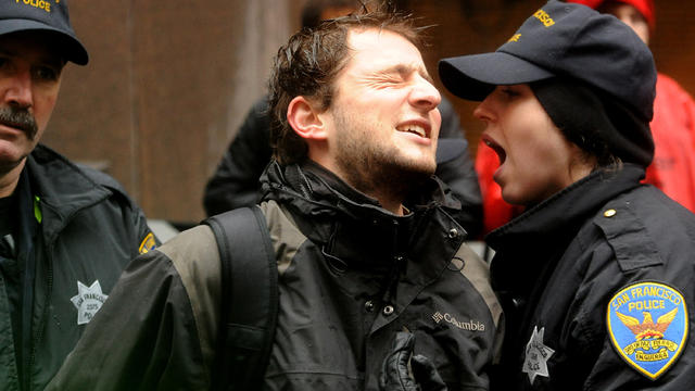 Police officers arrest an Occupy protester outside a Bank of America branch Jan. 20, 2012, in San Francisco. Anti-Wall Street demonstrators across the U.S. planned rallies in front of banks and courthouses. 