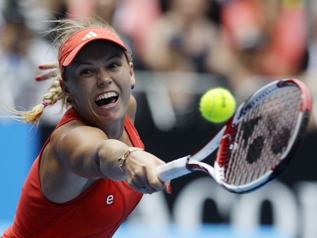Caroline Wozniacki reaches for a backhand return  