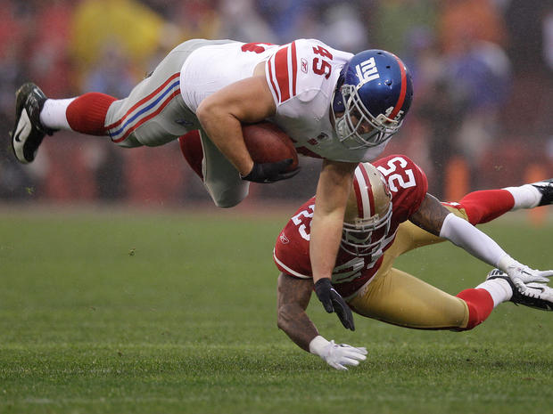 Henry Hynoski is tackled by San Francisco 49ers' Tarell Brown 