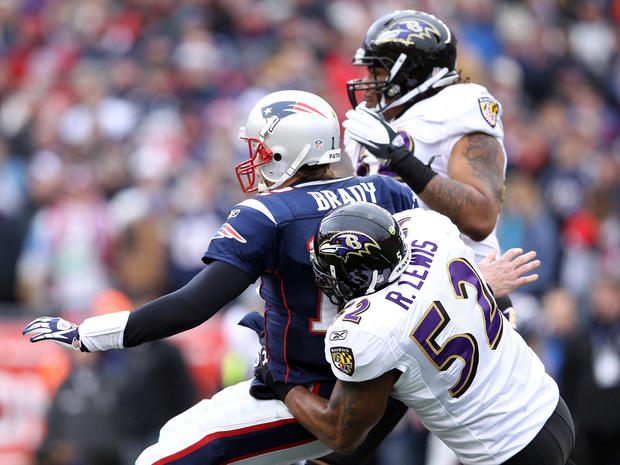 Tom Brady gets tackled after throwing the ball by Ray Lewis 