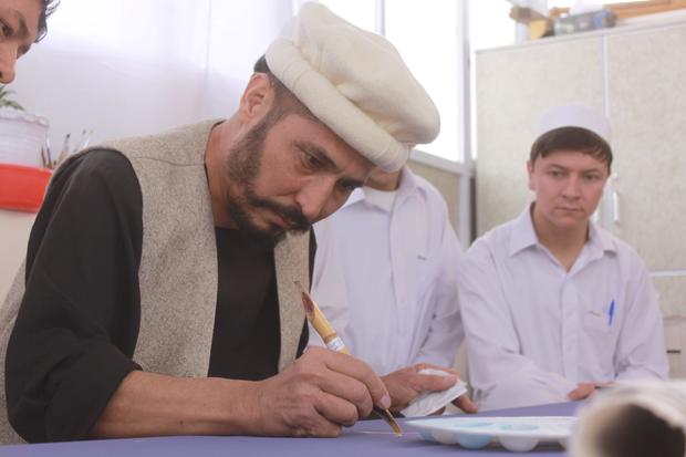 Calligrapher Mohammed Sabeer Hussani, 52, works on his huge Quran 