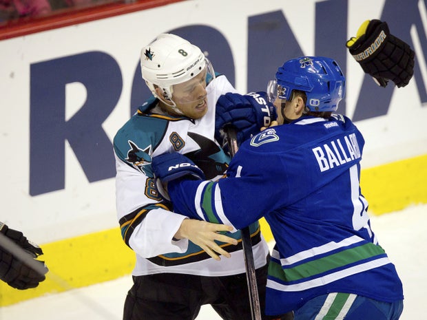 Joe Pavelski throws his gloves off as he fights with Keith Ballard  