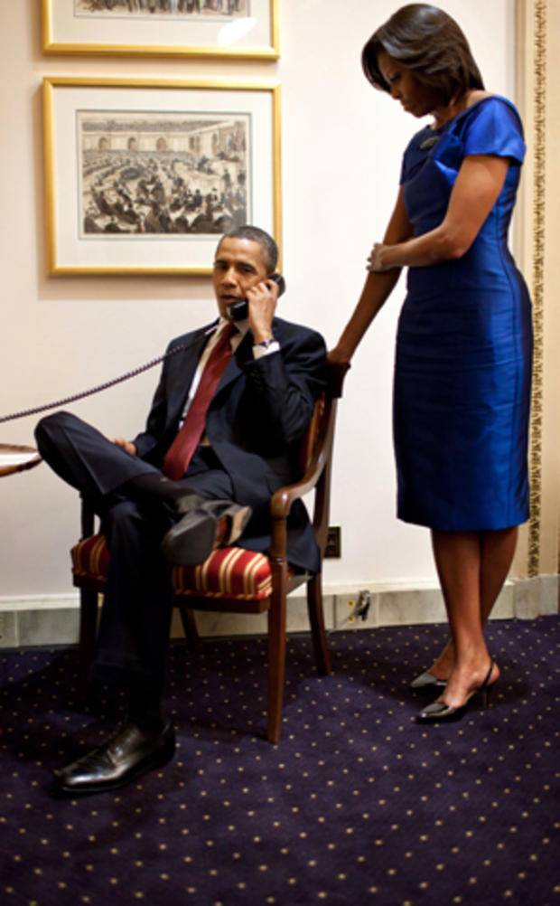 President Obama, accompanied by first lady Michelle Obama, is seen on a phone call at the Capitol in Washington Jan. 24, 2012, immediately after his State of the Union address, informing John Buchanan that his daughter Jessica was rescued by U.S. special operations forces in Somalia. 