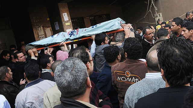 Mourners carry the body of a victim of clashes at a soccer stadium outside a morgue in Cairo, Egypt, Feb. 2, 2012.  