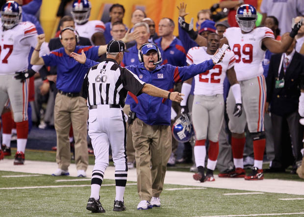 Tom Coughlin argues a call with an official  