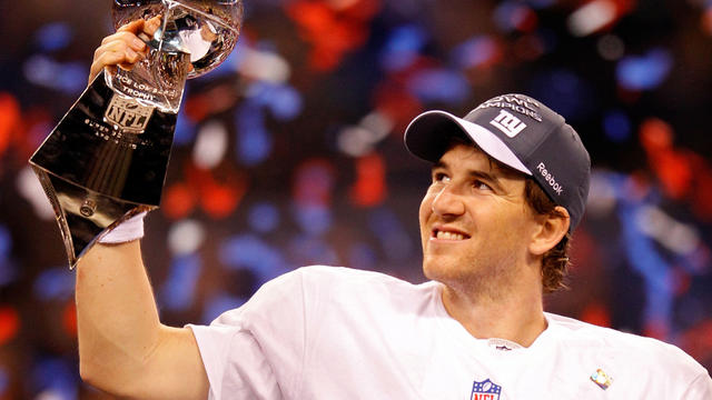 Eli Manning poses with the Vince Lombardi Trophy  