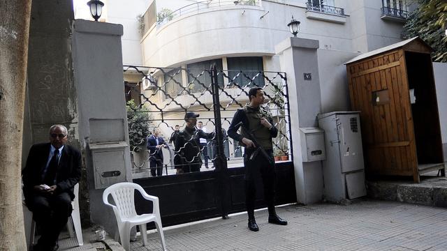 Egyptian soldiers stand guard in front of the U.S. National Democratic Institute 