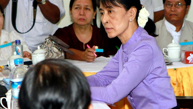 Burma pro-democracy icon Aung San Suu Kyi, right in front, accepts candidate list of her National League for Democracy at Yangon District Elections Commission Office for upcoming elections Monday, Feb. 6, 2012 in Yangon, Burma.  
