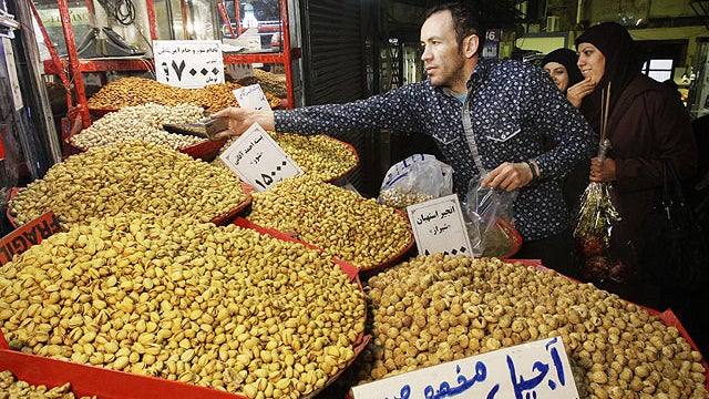 In this Feb. 2, 2012 photo, an Iranian vendor sells pistachio in Tehran's old main bazaar, Iran.  