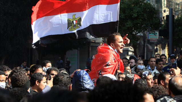 An Egyptian protester carried by fellow demonstrators shouts slogans near the Interior Ministry in Cairo Feb. 4, 2012. 