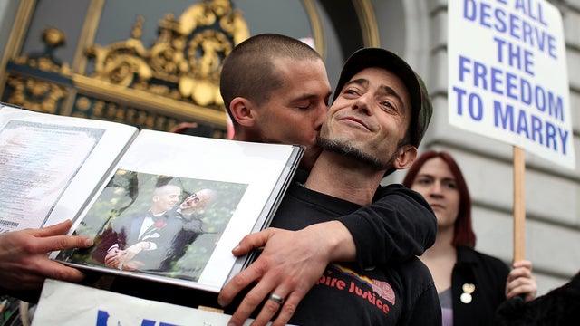 Same-sex couple Frank Capley-Alfano, left, and Joe Capley-Alfano kiss as they celebrate outside San Francisco City Hall Feb. 7, 2012, in San Francisco. A three-judge panel of the 9th U.S. Circuit Court of Appeals ruled that the voter-approved Proposition  