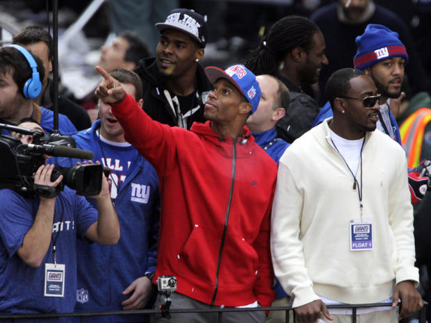 New York Giants' Victor Cruz, center, points to fans during the team's NFL football Super Bowl parade 