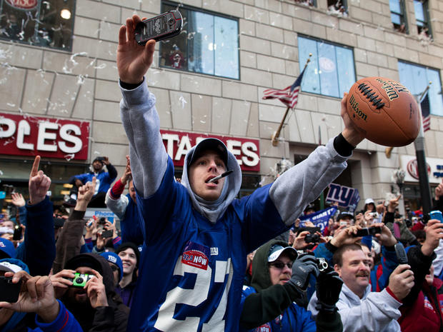 New York Giants fans cheer and reach for autographs from the players 