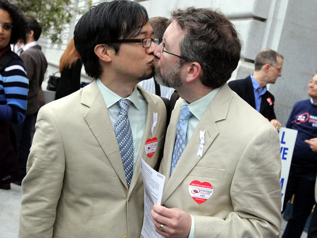 Same-sex couple Jeff Tabaco, left, and Thom Watson kiss as they hold paperwork for a marriage license Aug. 12, 2010, in San Francisco. 