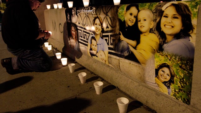 Ken Landgrebe lights a candle next to photographs of Susan Cox Powell and her sons Braden and Charlie during a candlelight vigil at McKinley Park in Tacoma, Wash., Feb. 6, 2012, the day after Braden and Charlie Powell were killed with their father, Josh P 