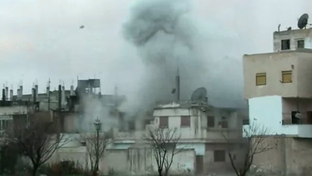 Homs building hit by artillery 