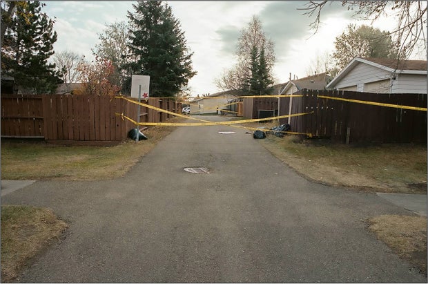 Gilles ran into the alley behind the garage and collapsed at this intersection in front of a couple out for a walk.