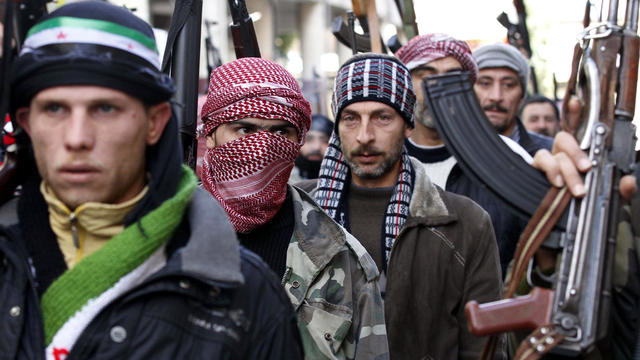 Syrian rebels march in show of strength during a demonstration in Idlib, Syria Friday 