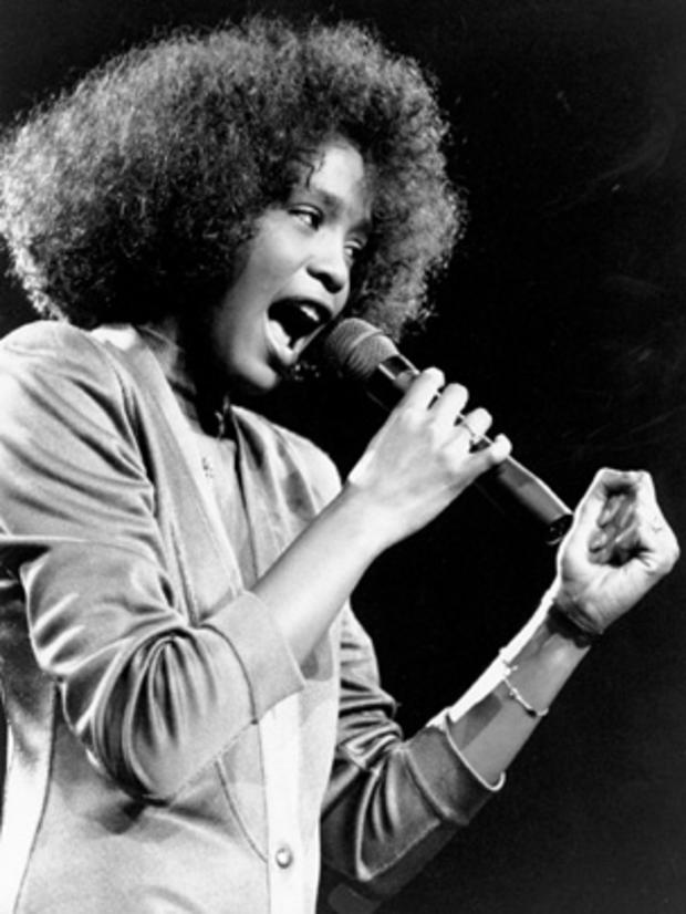 Singer Whitney Houston belts out a song during her segment of a benefit concert at Boston Garden on May 10, 1986. 