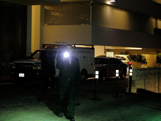 Security gather outside the Beverly Hilton Hotel Saturday Feb. 11, 2012 in Beverly Hills Calif. 
