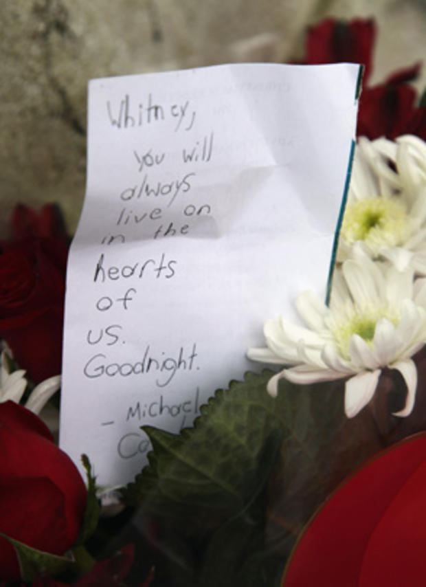 Flowers and notes of sympathy are laid at the entrance of Whitney Houston's former home in  Mendham, N.J. 