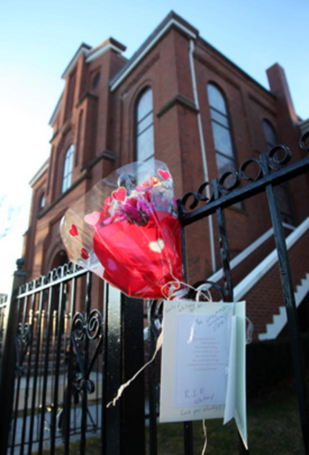Flowers and a sympathy card hang on a fence in front of New Hope Baptist Church in Newark, N.J. 