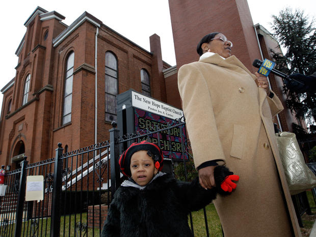 Shalana Gaston answers a question as they leave New Hope Baptist Church in Newark, N.J. 