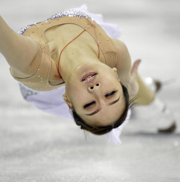 Yue Zhang is spun by Lei Wang while competing in the pairs short program 