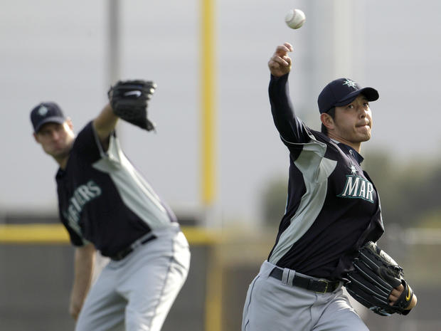 Hisashi Iwakuma throws during spring training 