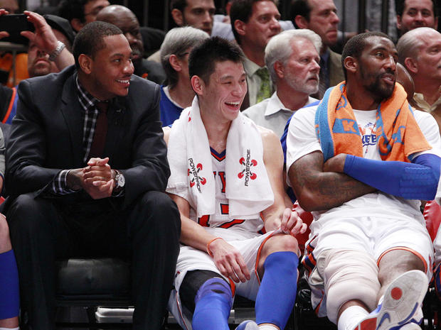 Jeremy Lin, center, talks with teammates Carmelo Anthony, left, and Amare Stoudemire 