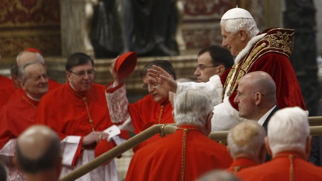 Pope Benedict XVI, right, makes his way through cardinals as he arrives inside St. Peter's Basilica at the Vatican to preside over a consistory, Saturday, Feb. 18, 2012. Pope Benedict XVI is bringing 22 new Catholic churchmen into the elite club of cardin 