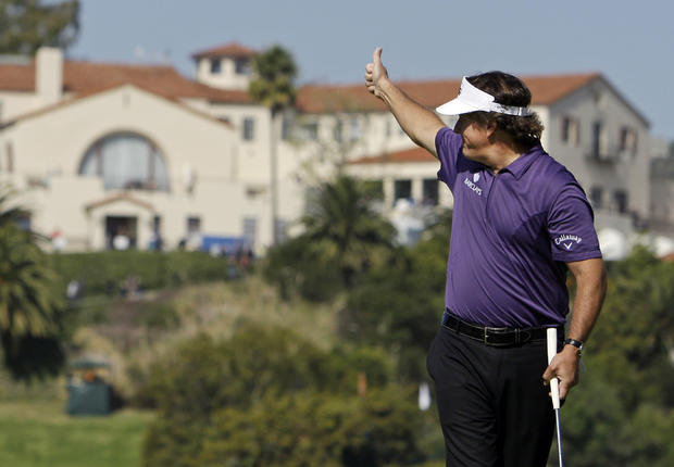 Phil Mickelson gives a thumbs-up to cheering fans  