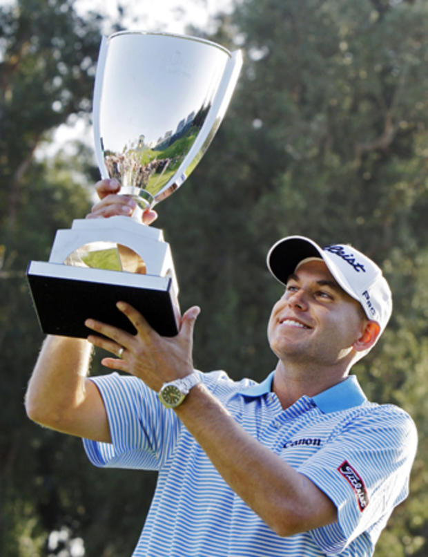 Bill Haas holds the winner's trophy after his victory in the Northern Trust Open 