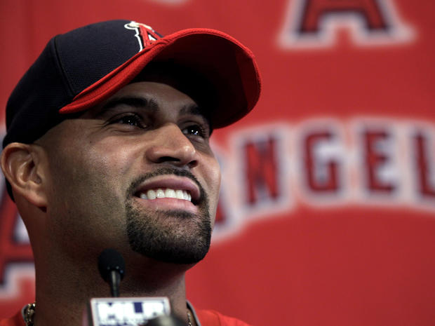Albert Pujols smiles during a news conference 