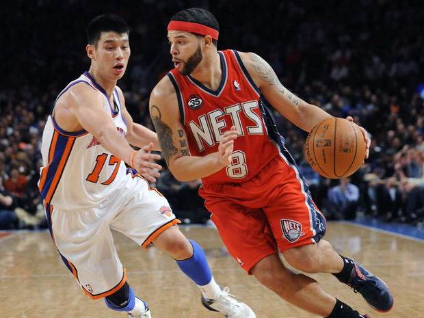 Deron Williams  drives to the basket as New York Knicks' Jeremy Lin defends 